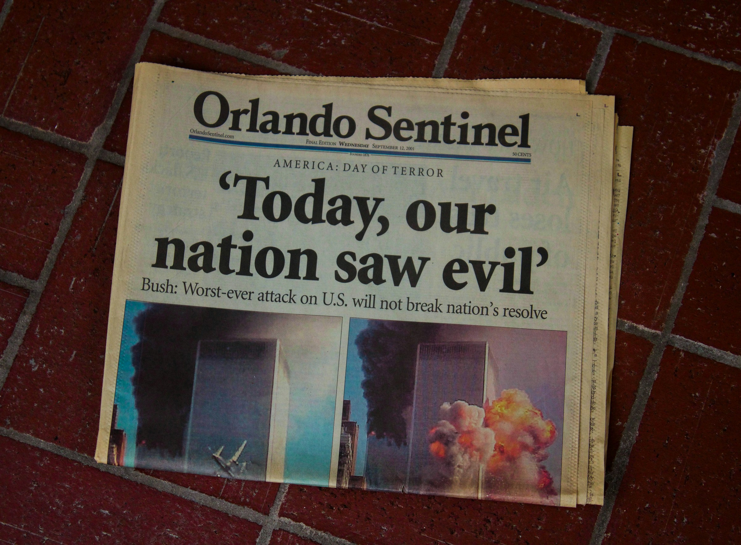 The front page of the Orlando Sentinel showing a headline on the 9/11 attacks that uses single quotes: 'Today, our nation saw evil' Bush: Worst-ever attack on U.S. will not break nation's resolve.