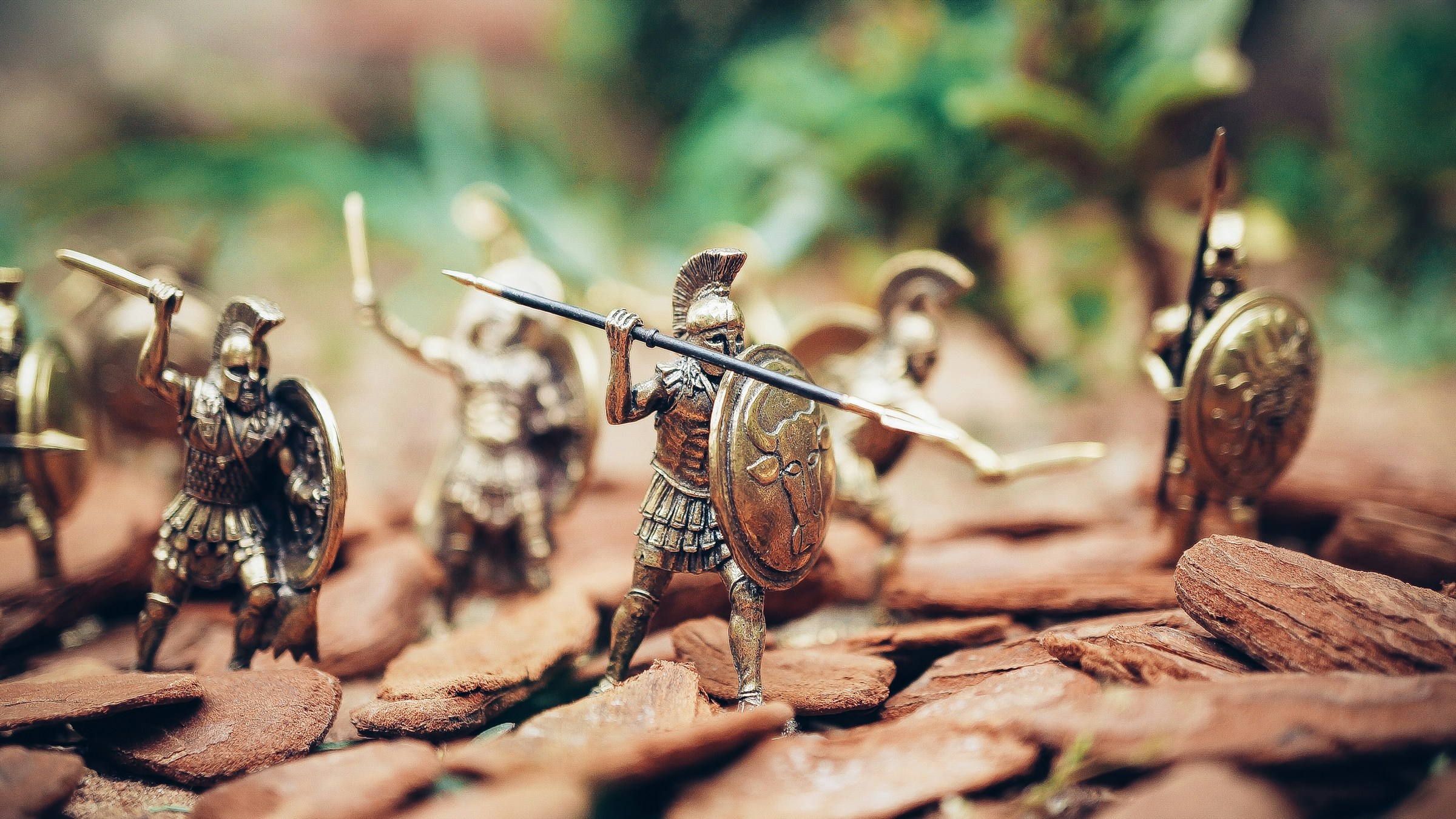 Toy warriors posed on rocks as if in battle.