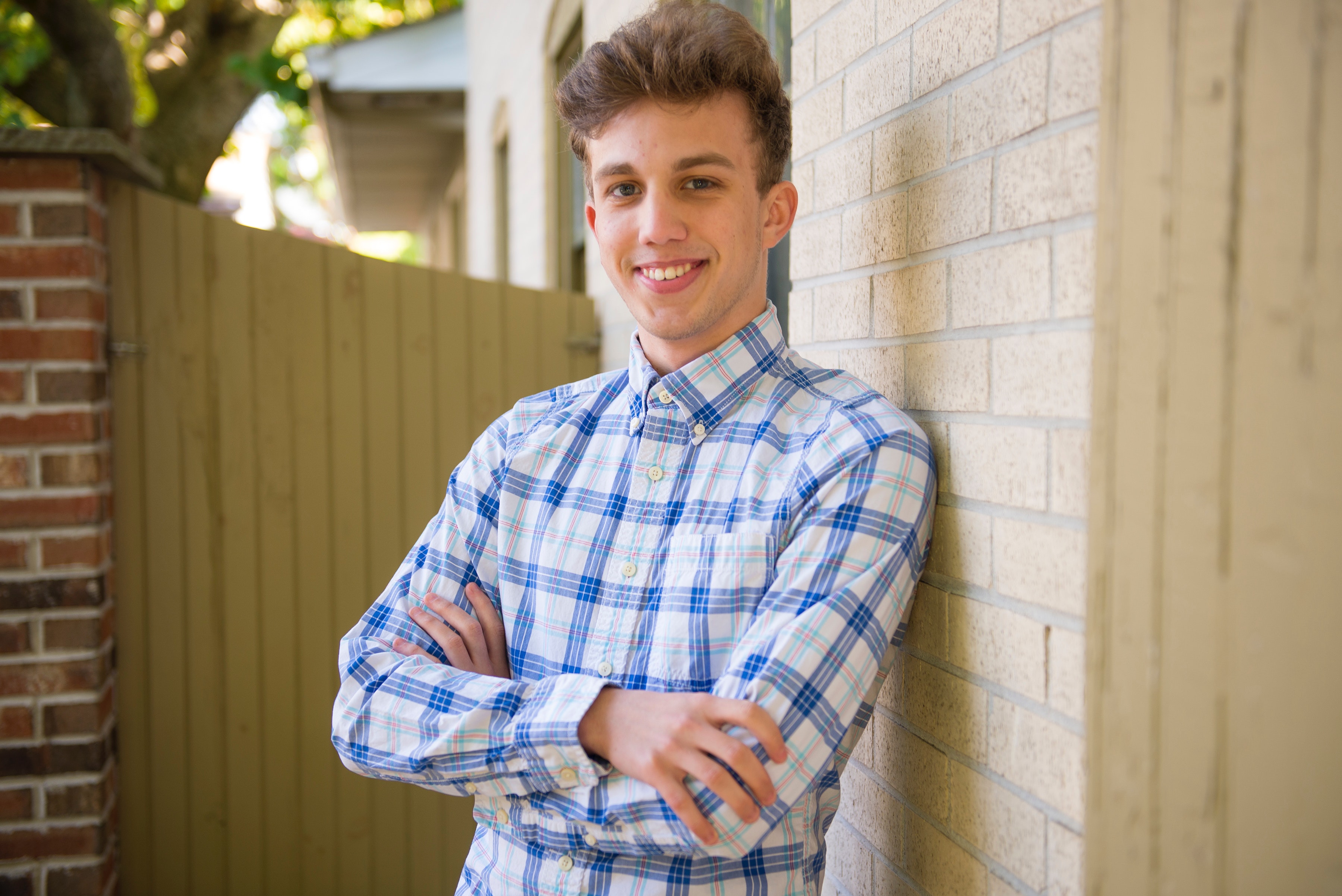 A young man leaning against a wall