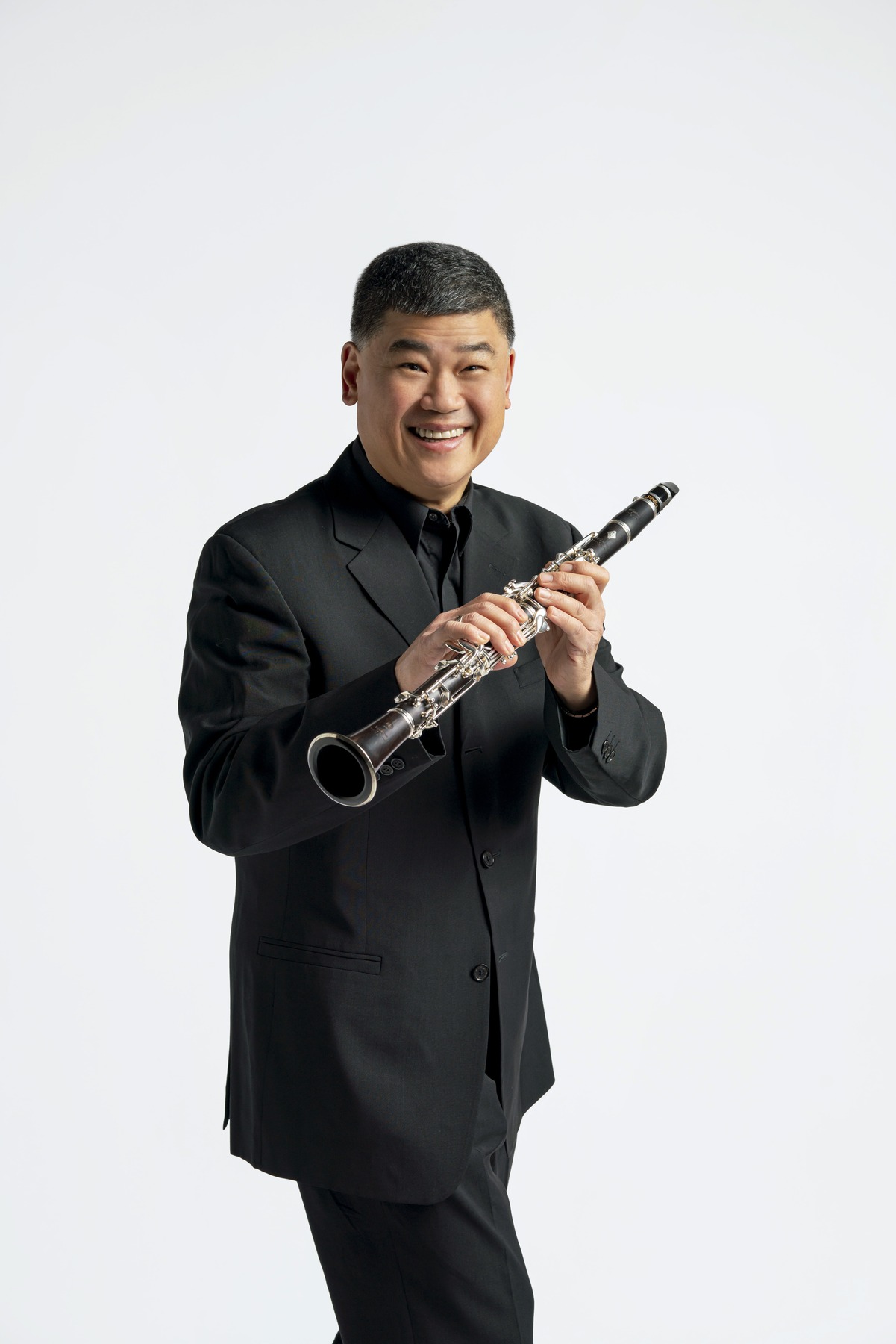 John Bruce Yeh holding a clarinet