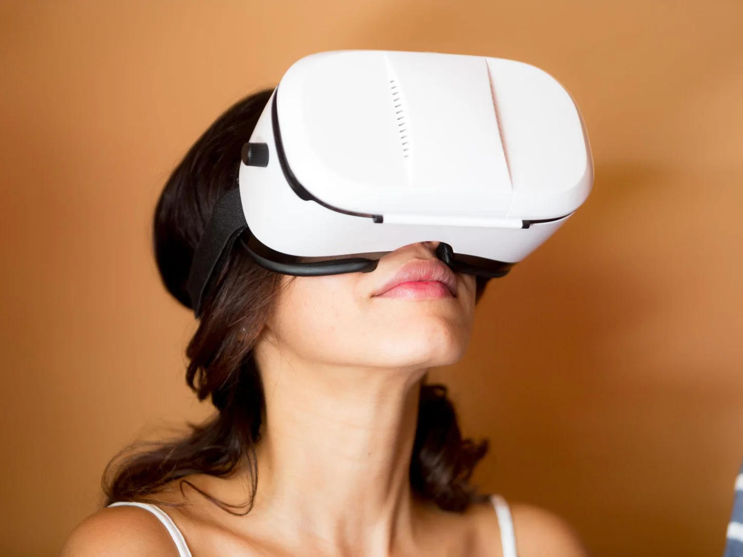 Woman wearing a virtual reality headset to experience immersive digital content