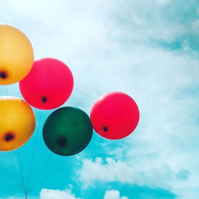 Colorful group of balloons flying in the sky
