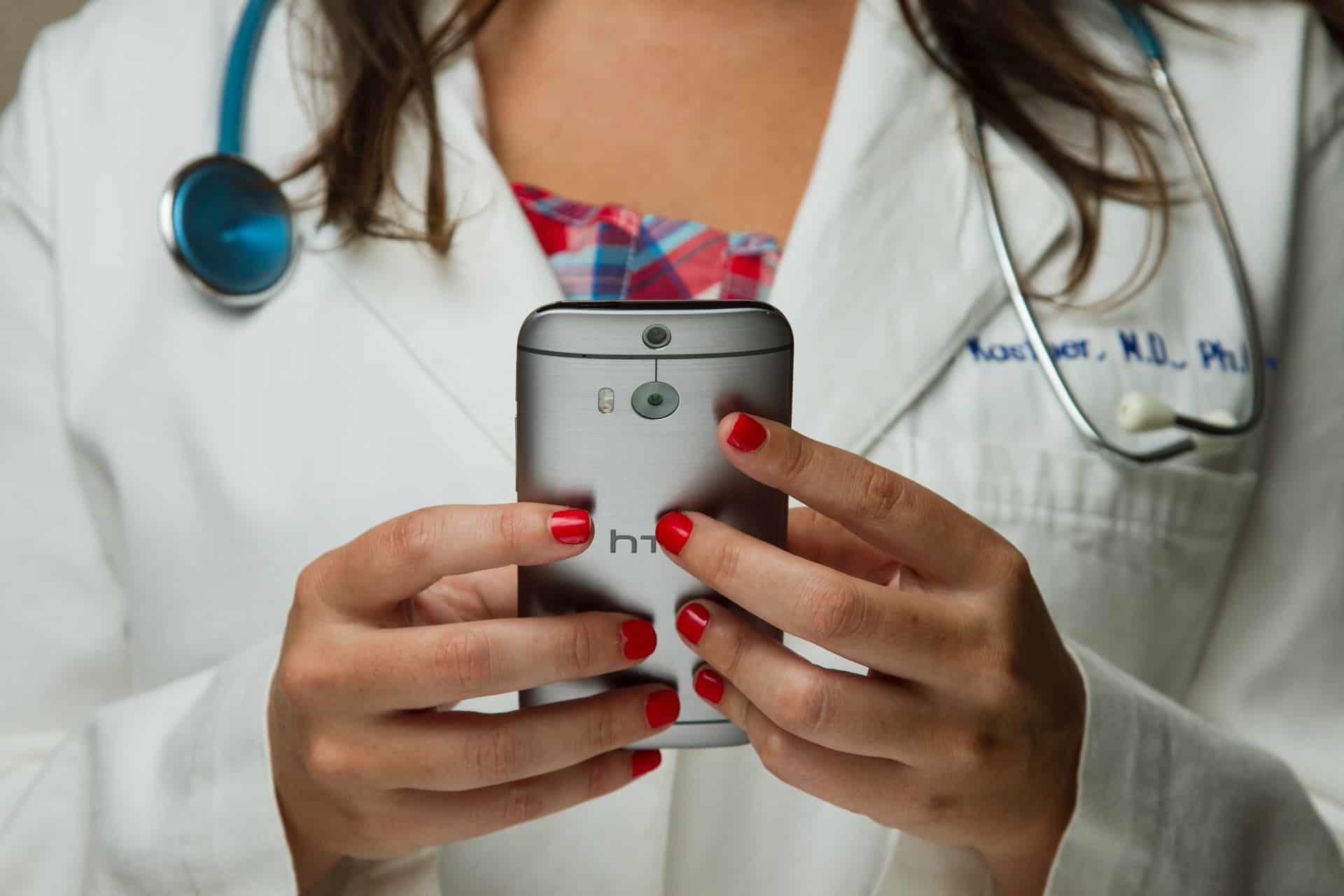 A doctor looking at patient messages on her smartphone. 