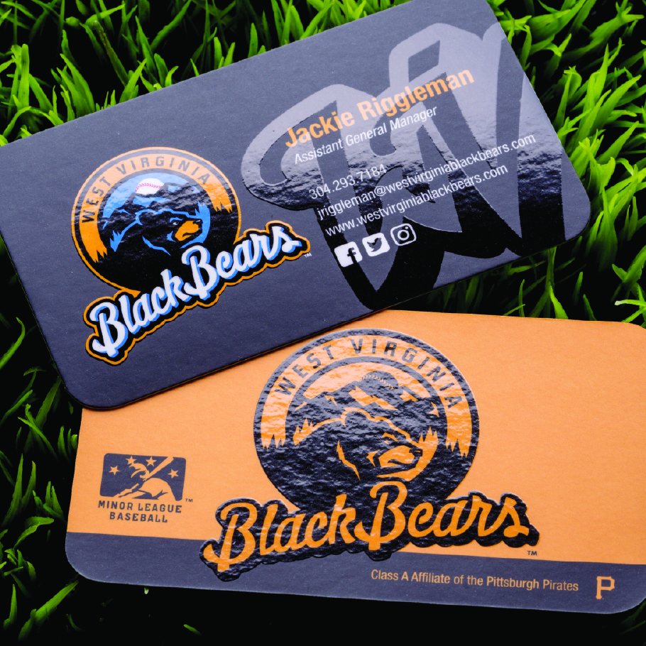 Two West Virginia Black Bears business cards, one black with contact details for Jackie Riggleman and one orange featuring the team logo and Minor League Baseball emblem.