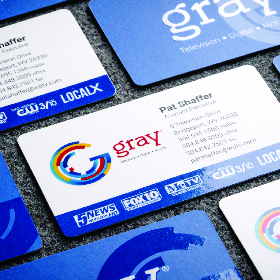 Gray business card for Pat Shaffer, Account Executive, with contact info and logos of local TV stations on blue border.