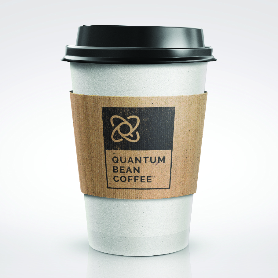 White disposable coffee cup with a black lid and a brown sleeve labeled Quantum Bean Coffee.