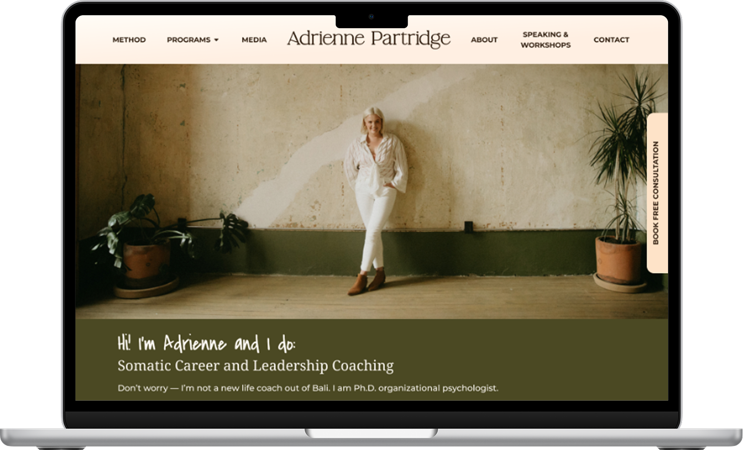 The homepage of Adrienne's new website, featuring a picture of her leaning on a plaster wall with plants to either side. The hero text says: "Hi, I'm Adrienne and I do: Somatic Career and Leadership Coaching. Don't worry -- I'm not a new life coach out of Bali. I am Ph.D. organizational psychologist."