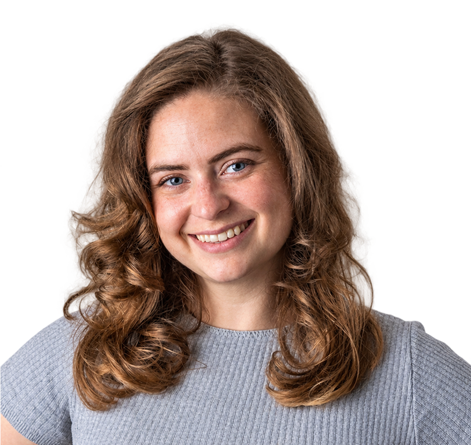 Photo of Katie Shultz smiling at the camera wearing a grey short sleeve ribbed shirt.