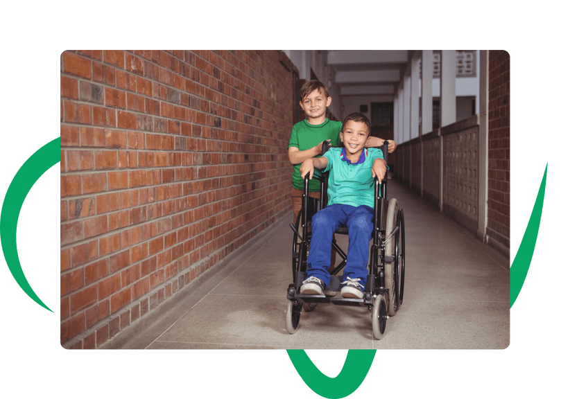 brother pushing sibling in a wheelchair