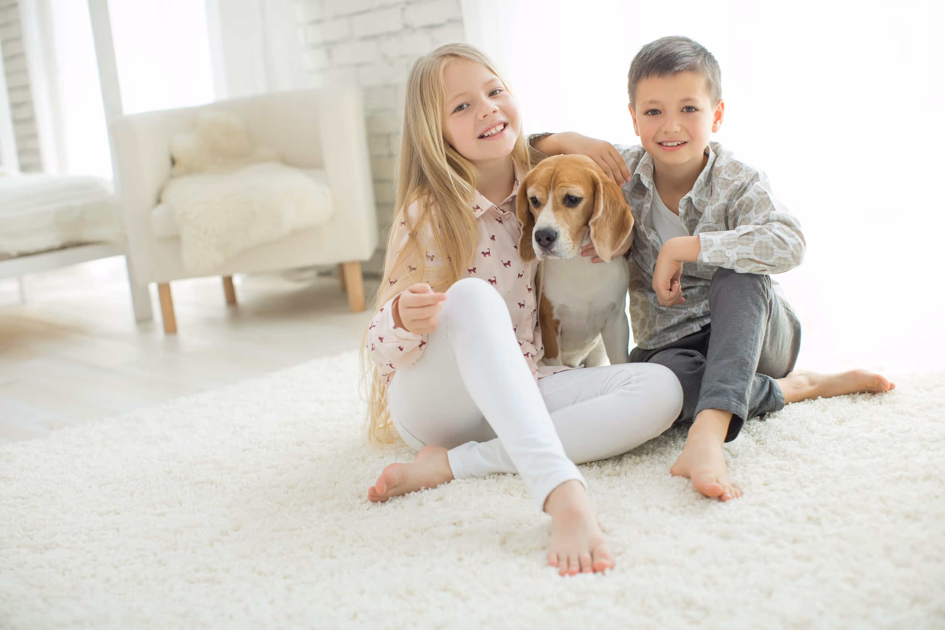 2 kids with their dog enjoying their new installed flooring