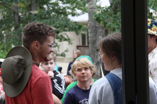 Three people riding horses down a road.