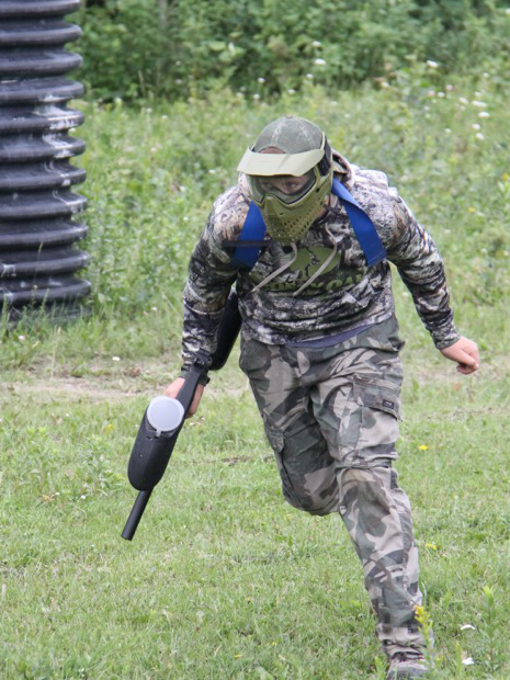 Three people riding horses down a road.