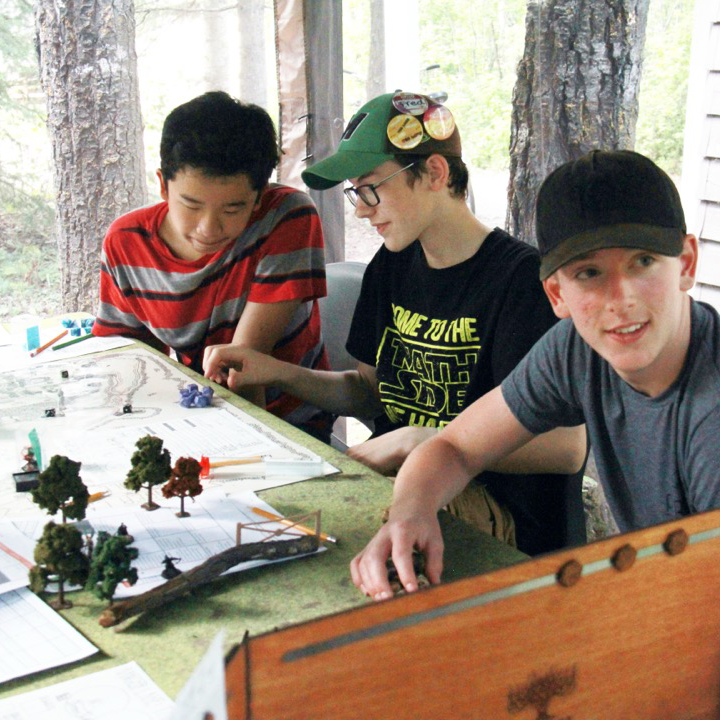 Kids on two tubes on a lake.