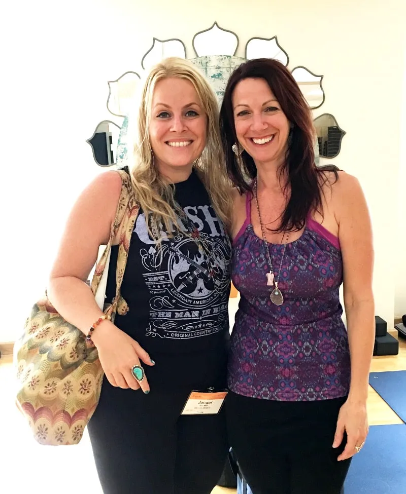 Two female teachers hugging and smiling