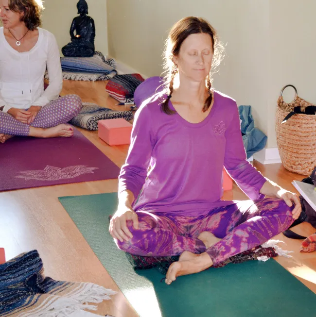 Student sitting cross-legged in meditation 