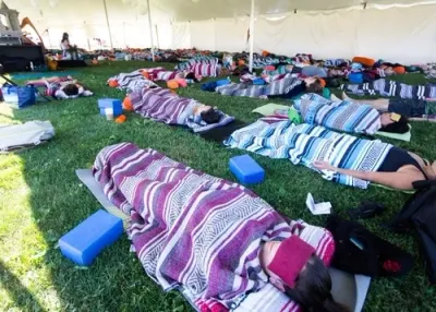 students lying on the ground practicing Yoga Nidra