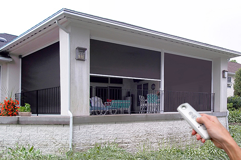Retractable patio shades installed on a screened porch