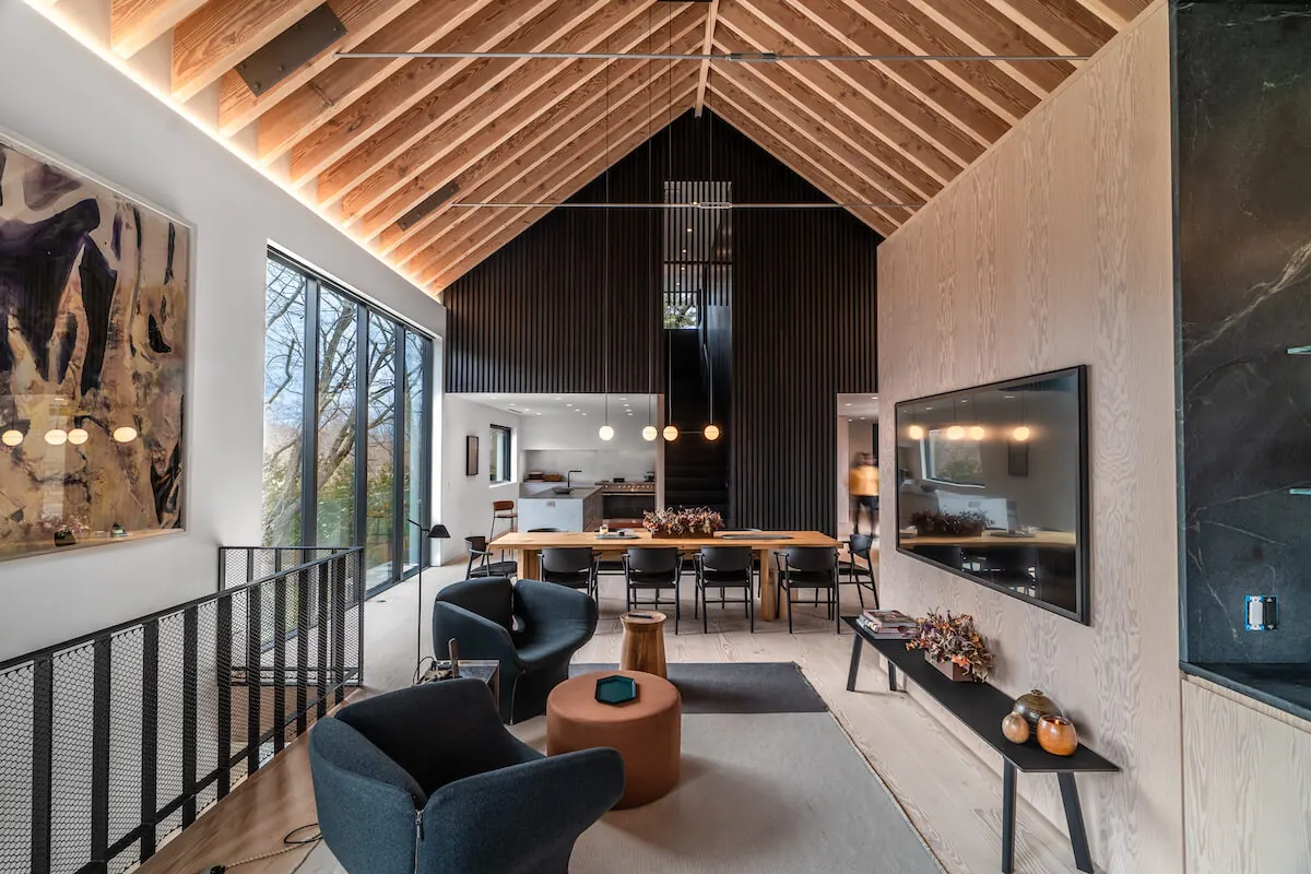 Living and dining space under a wood ceiling at the Westchester Residence, lighting control by PSE