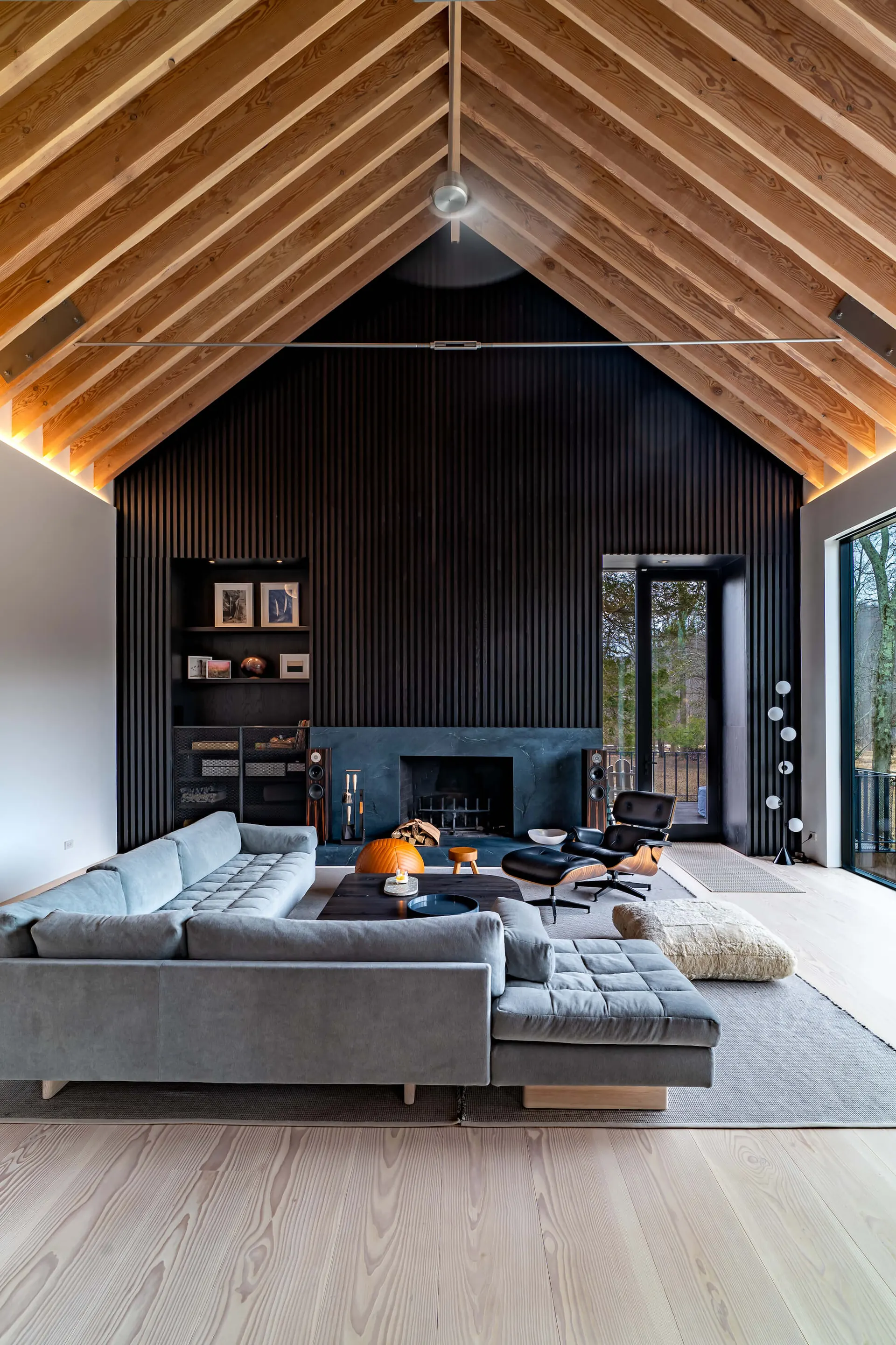 Great room with a sectional sofa and fireplace at the Westchester Residence, lighting control by PSE