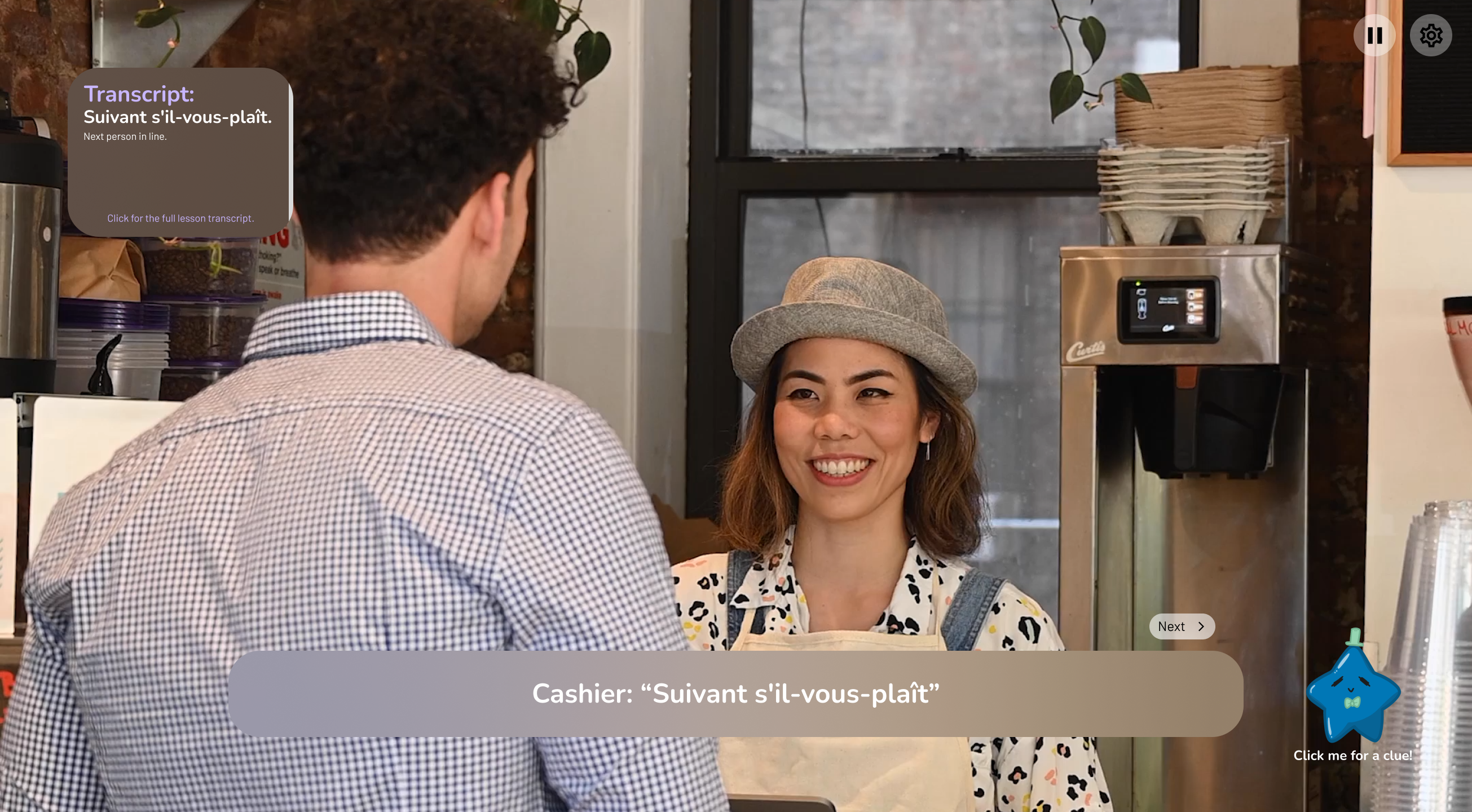 Smiling female cashier wearing a hat talking to a man in a checkered shirt at a coffee shop counter.