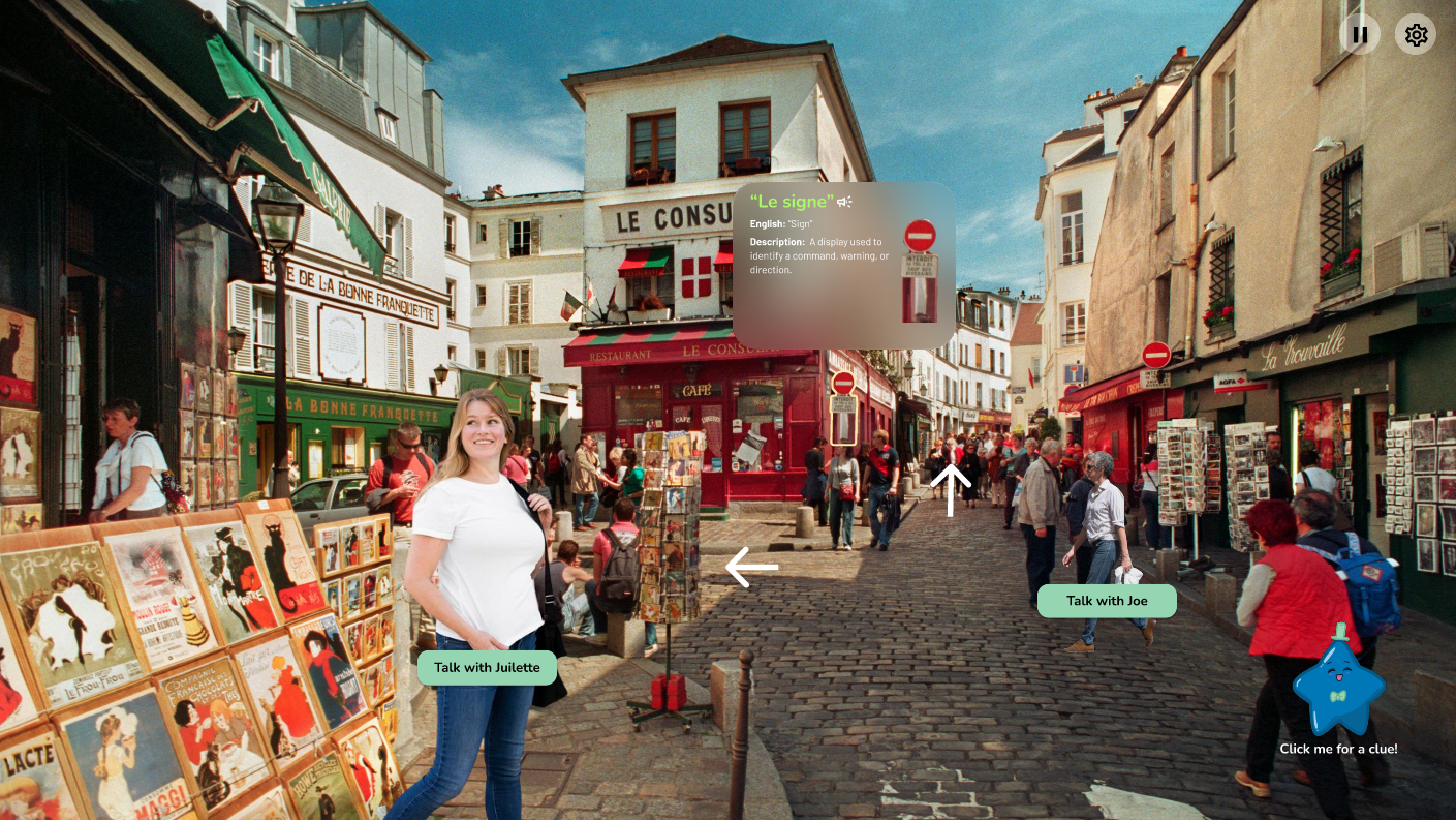 Street scene in a European town with cobbled road, people walking, outdoor art stands, and a woman in a white shirt labeled 'Talk with Juliette.'