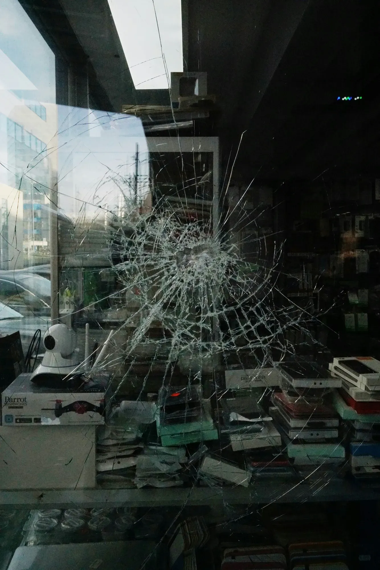 Cracked storefront glass illustrating the need for safety and security window film