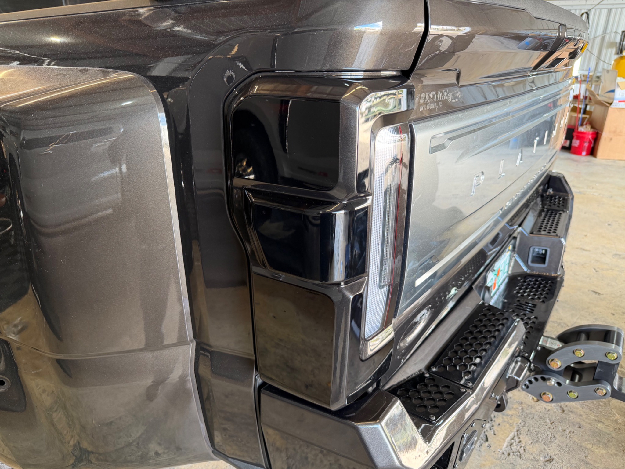 Close-up of a gray Ford truck’s tailgate and rear lighting details
