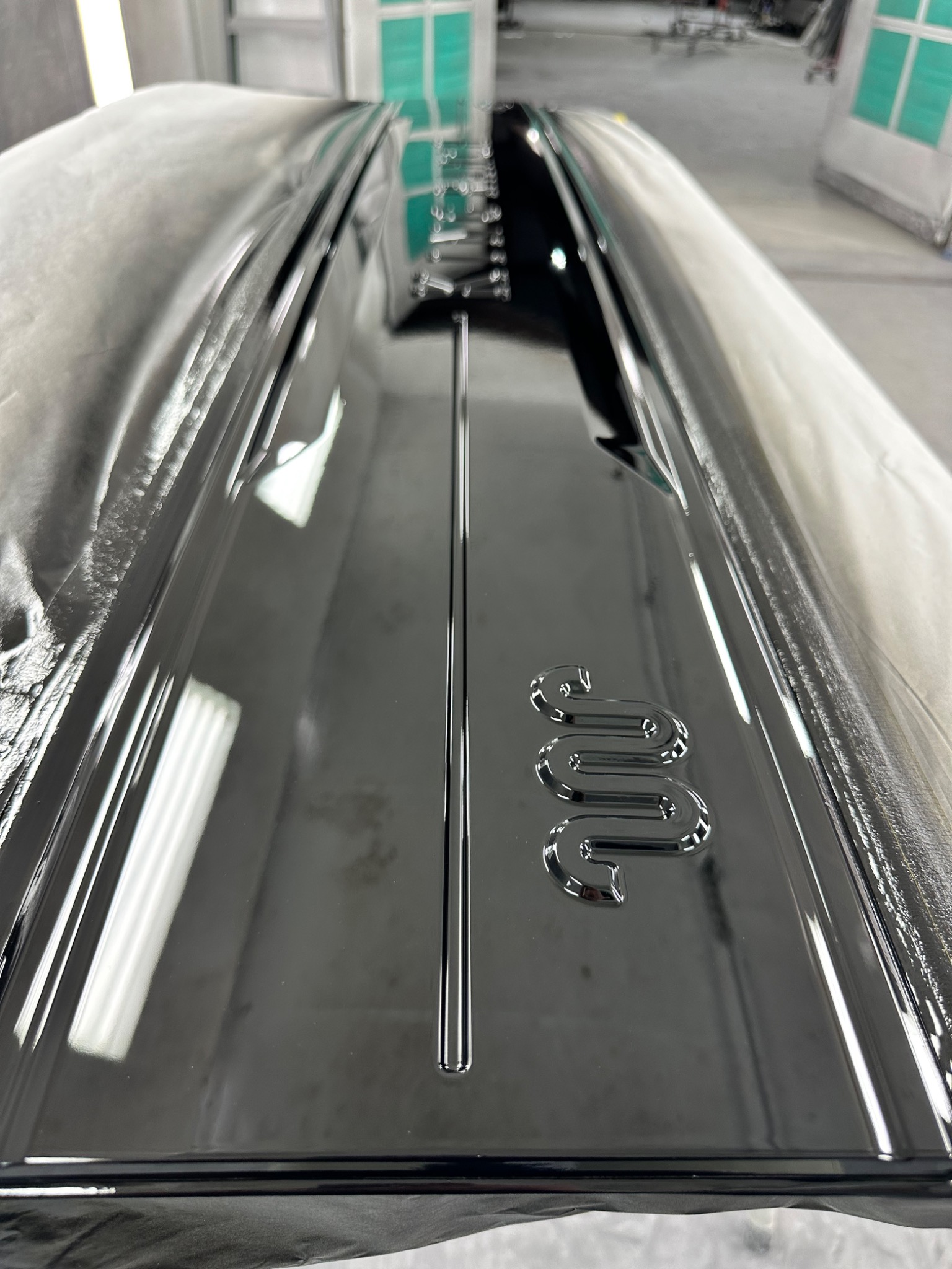 Glossy custom-painted automotive panel with detailed black finish