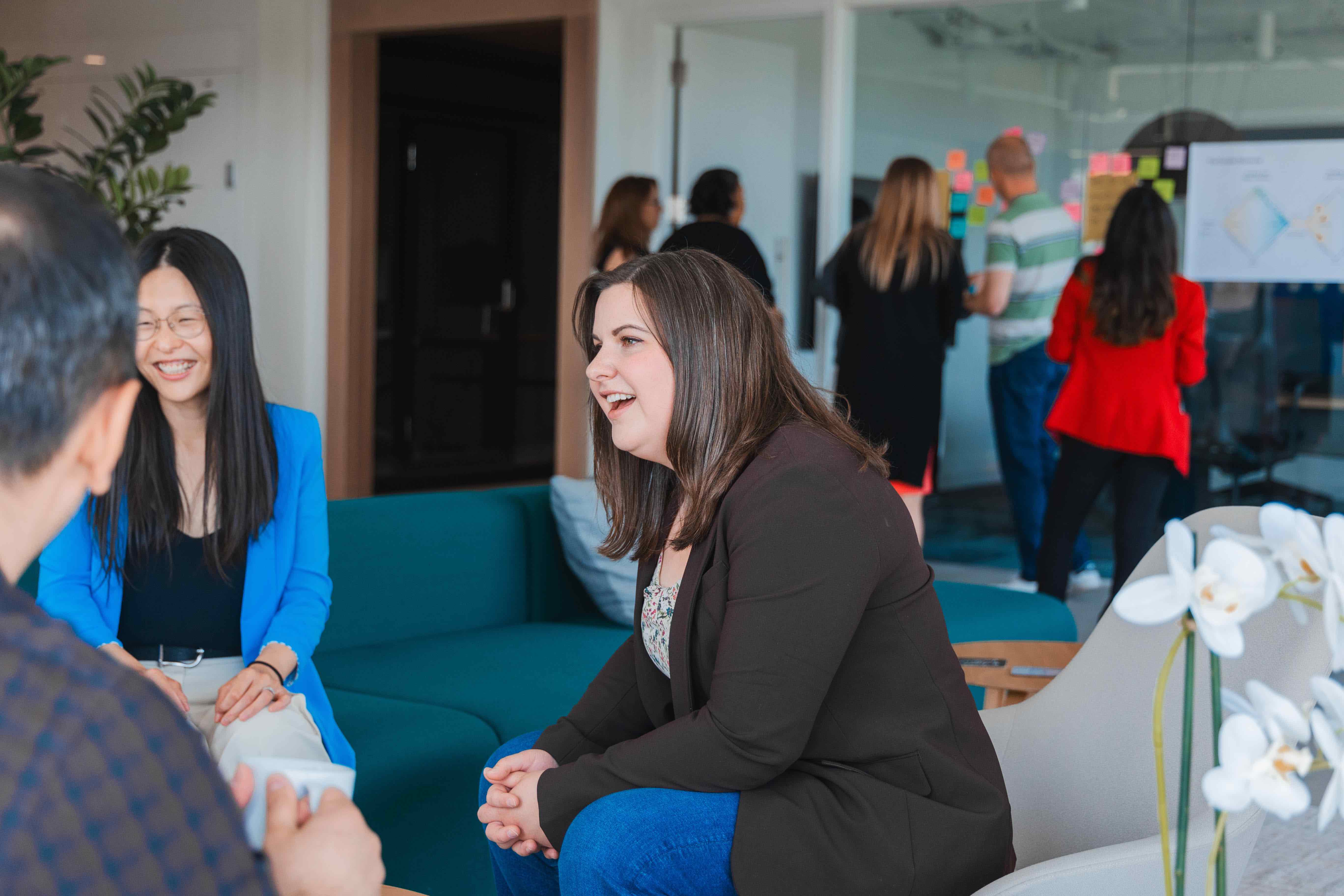 People mingling, some are seated in conversation while others are standing in the background.