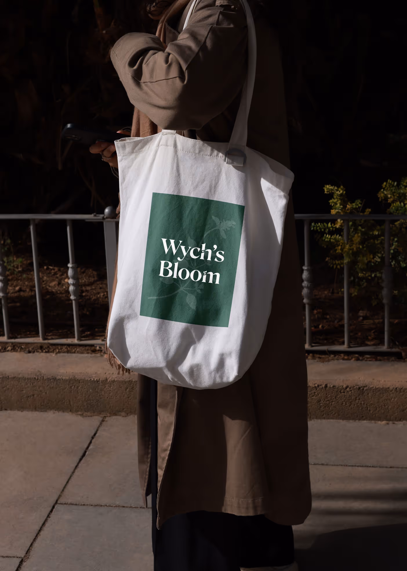 Person standing with a branded tote bag