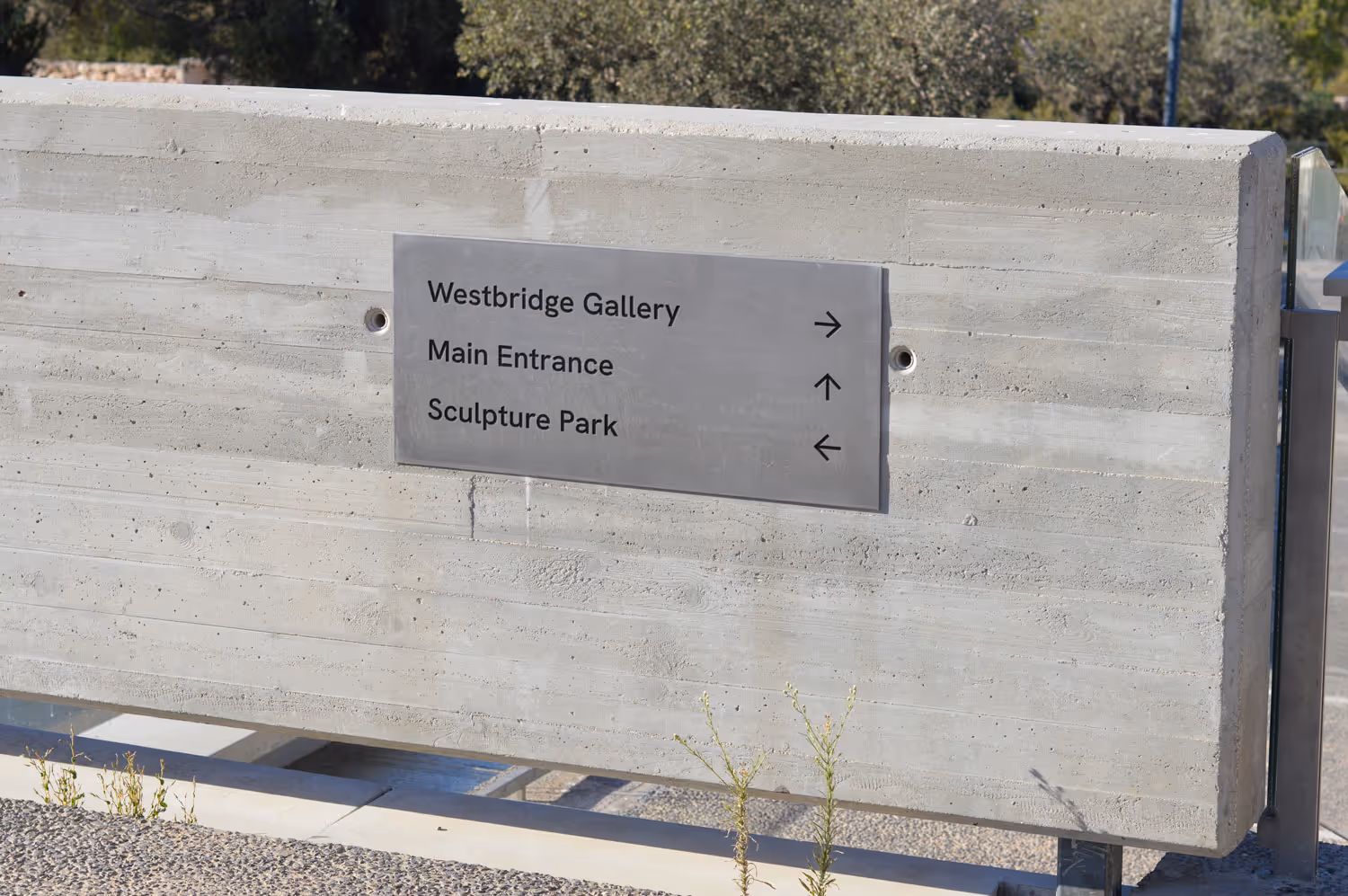 outdoor sign giving directions to different places at the museum
