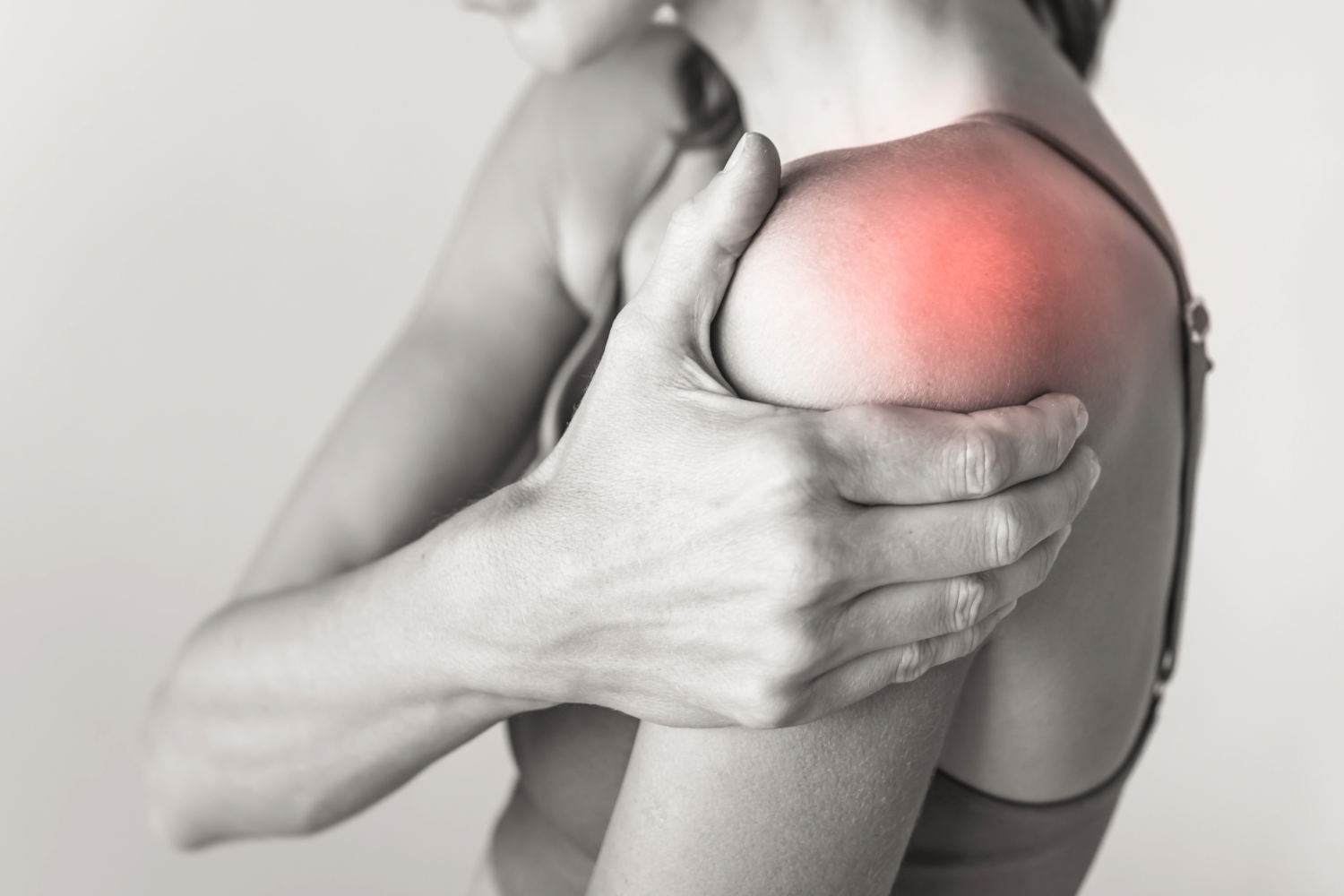 Woman holding painful shoulder