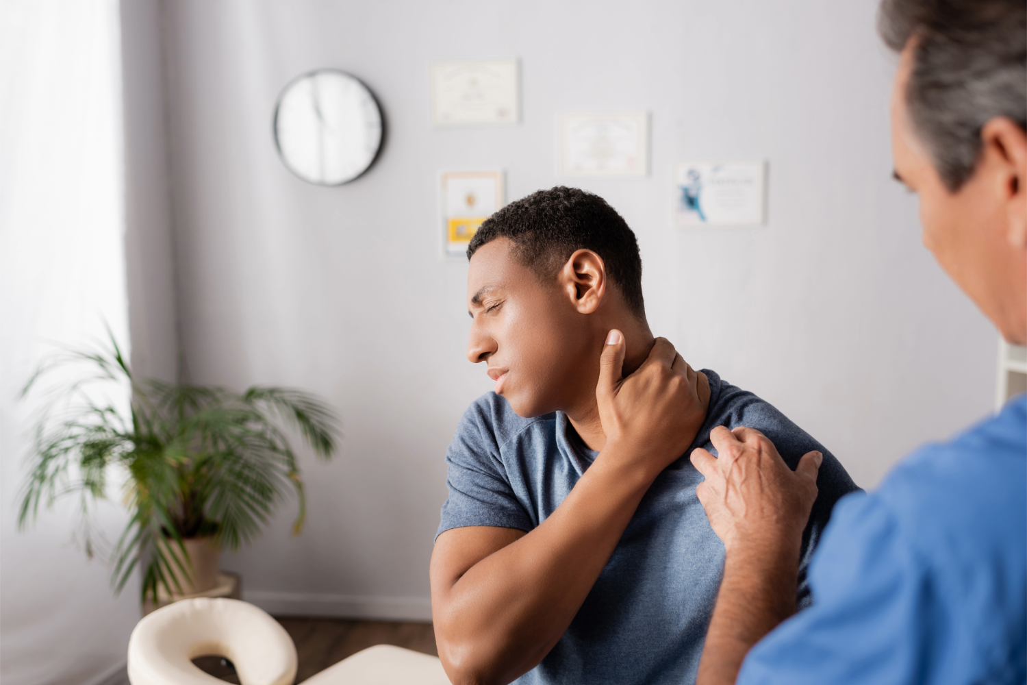 Man receiving shoulder examination in clinic
