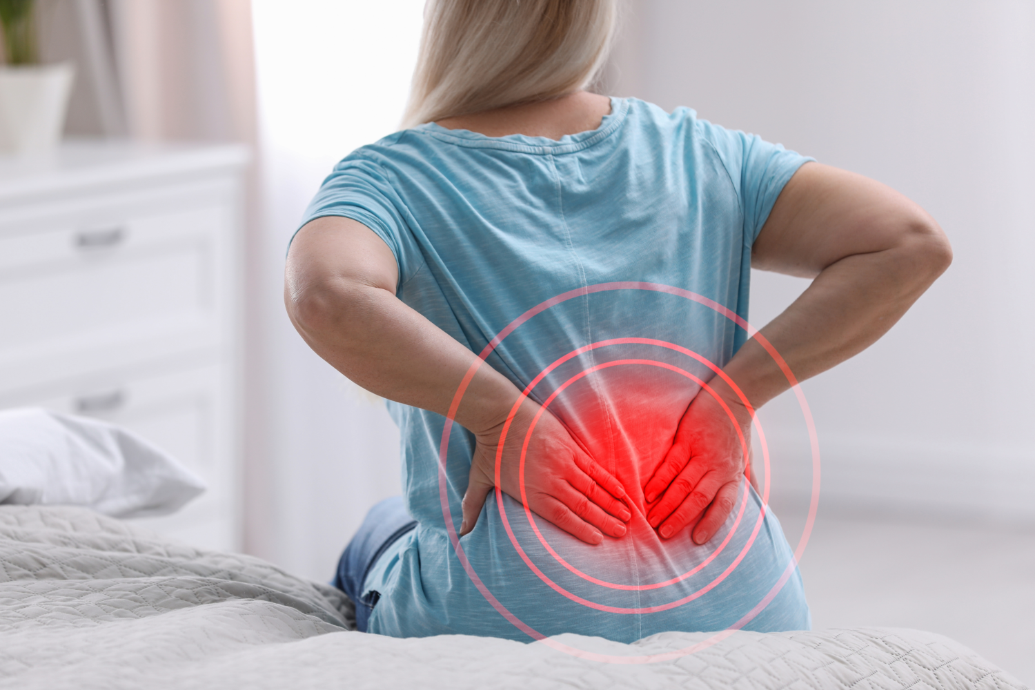 Woman with back pain highlighted red.