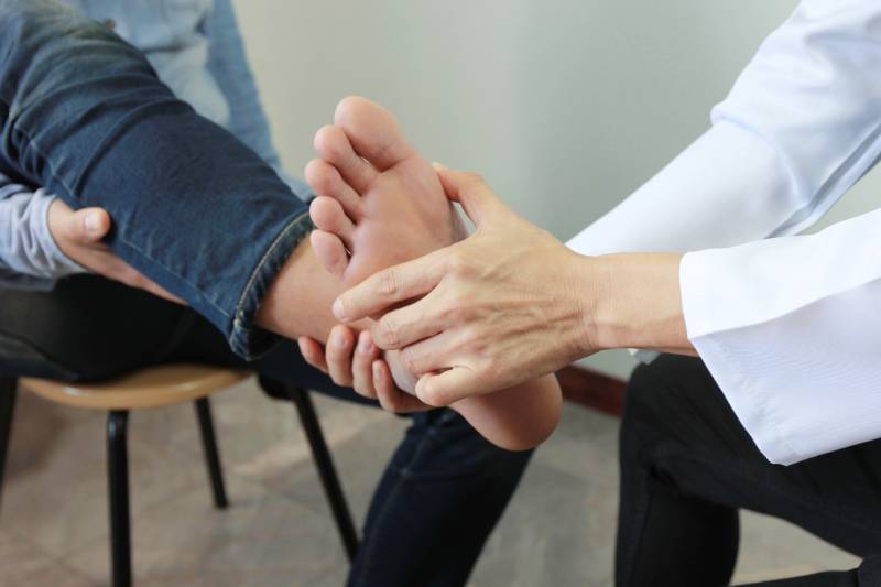 Doctor examining patient's foot