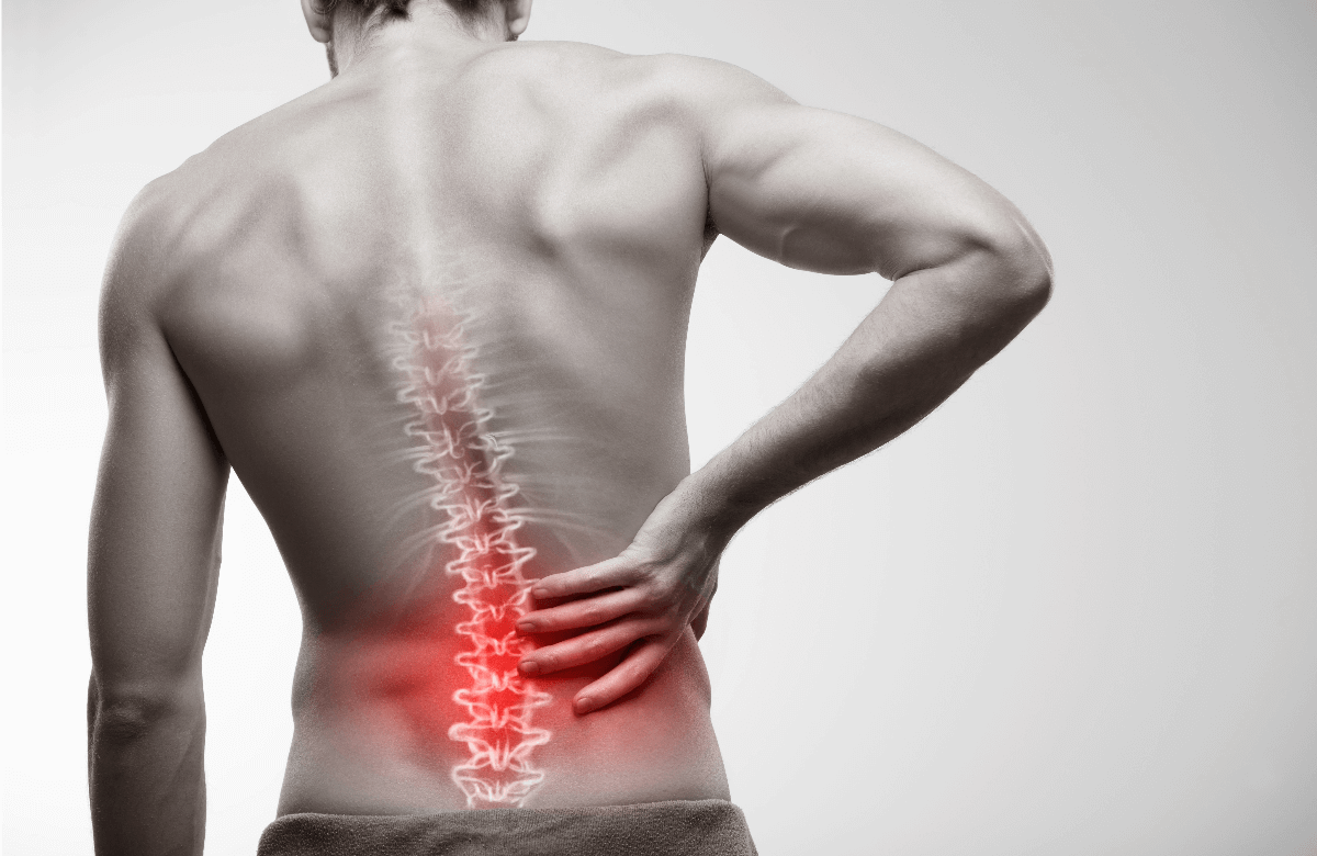 Man holding lower back with highlighted spine pain