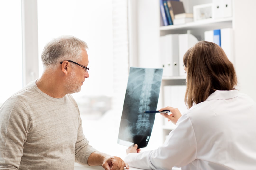 Doctor and patient reviewing spine X-ray