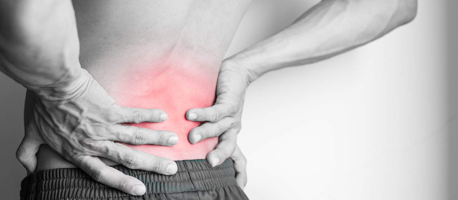Person holding painful lower back
