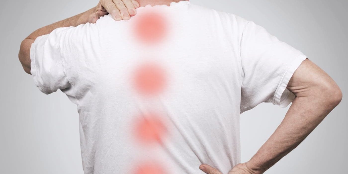 Man with back pain, red spots on spine.