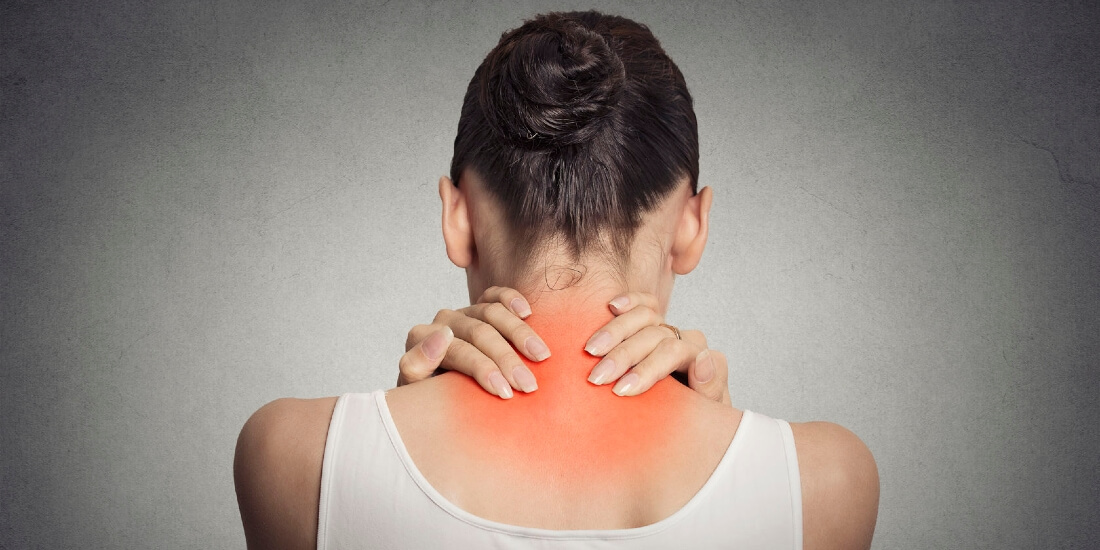 Woman holds neck with red pain area.