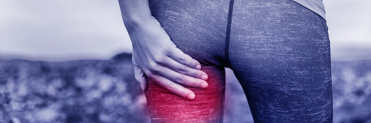 Person holding painful thigh