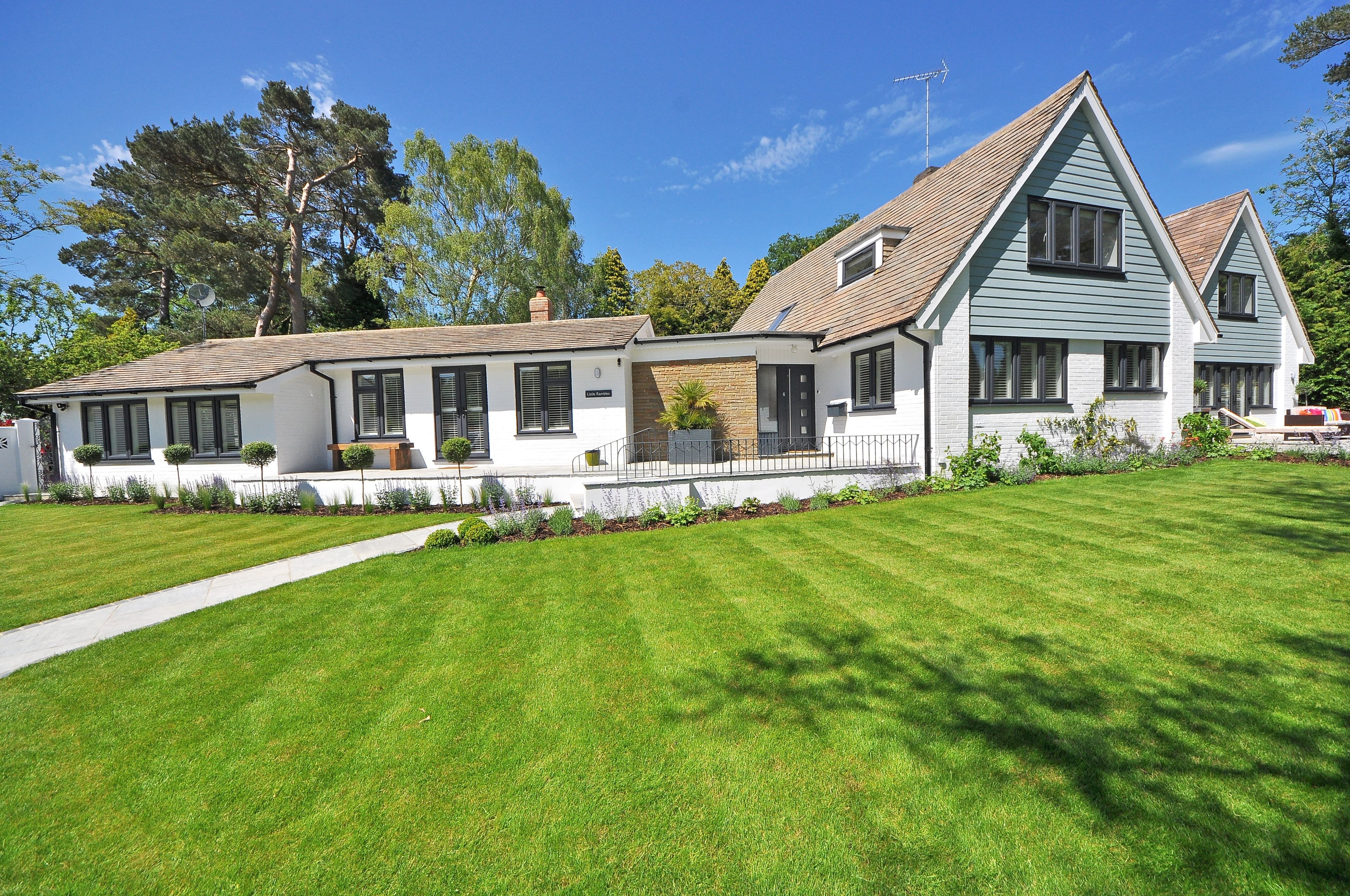 Image of a white house on a property with fresh cut grass