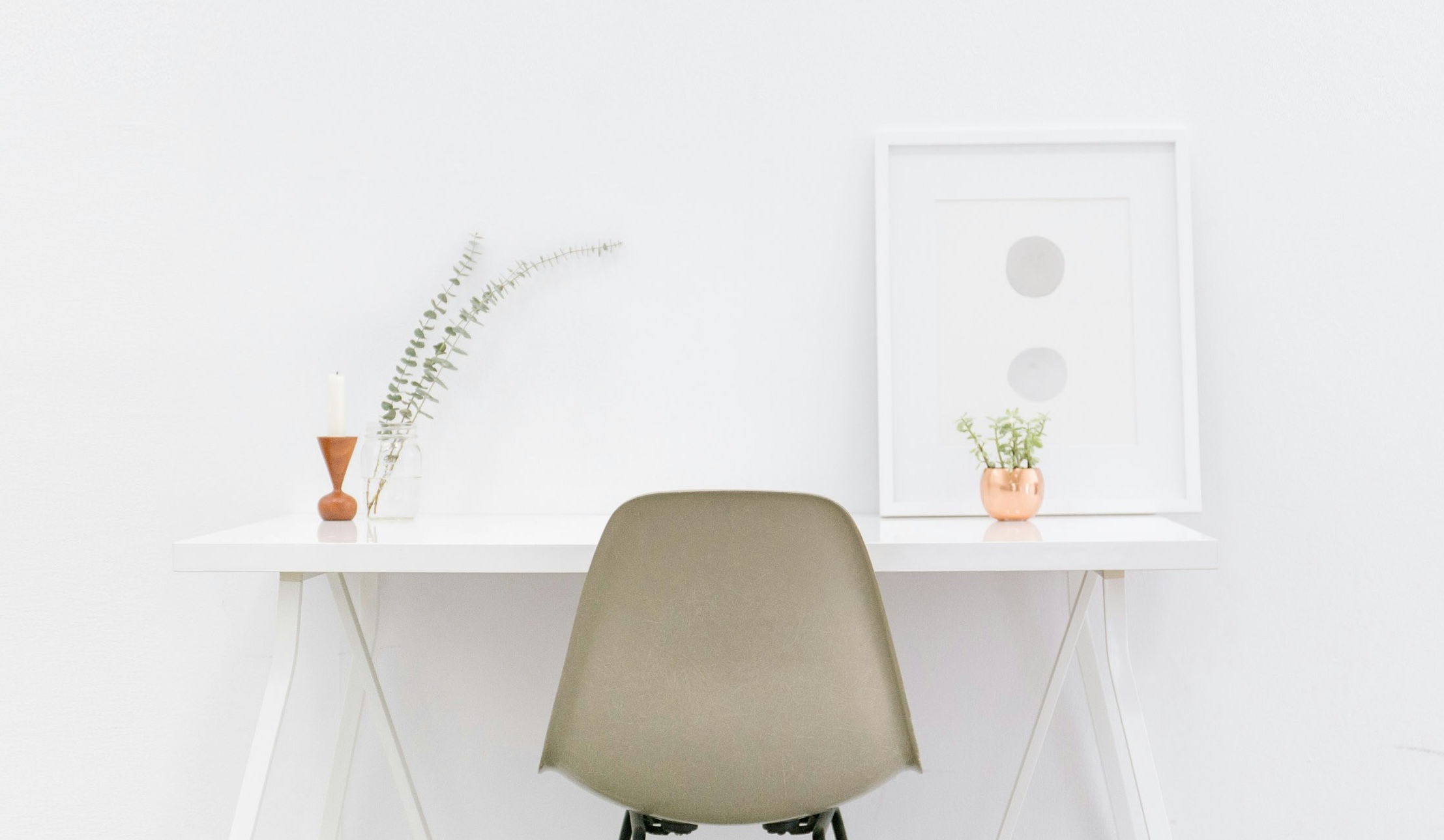 Desk and chair; clean white wall and minimal desk
