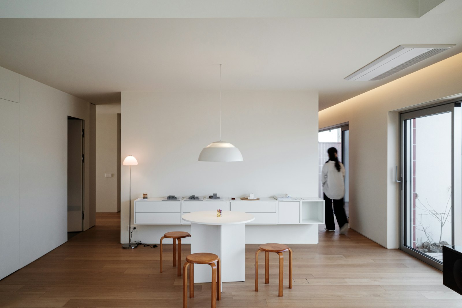 Bright, minimalist living room with white furniture
