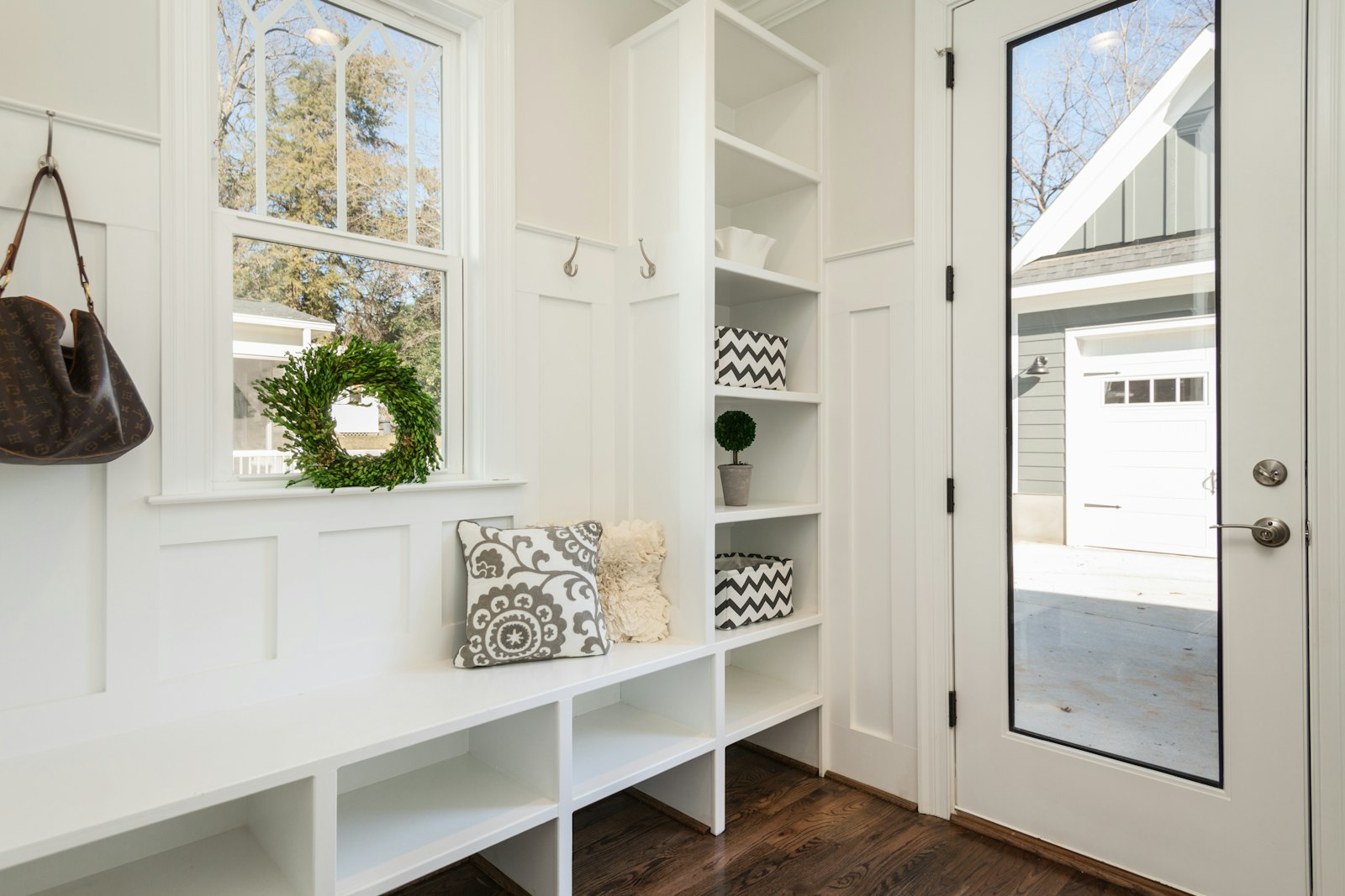 Organized mudroom entryway with a rack for coats and bags