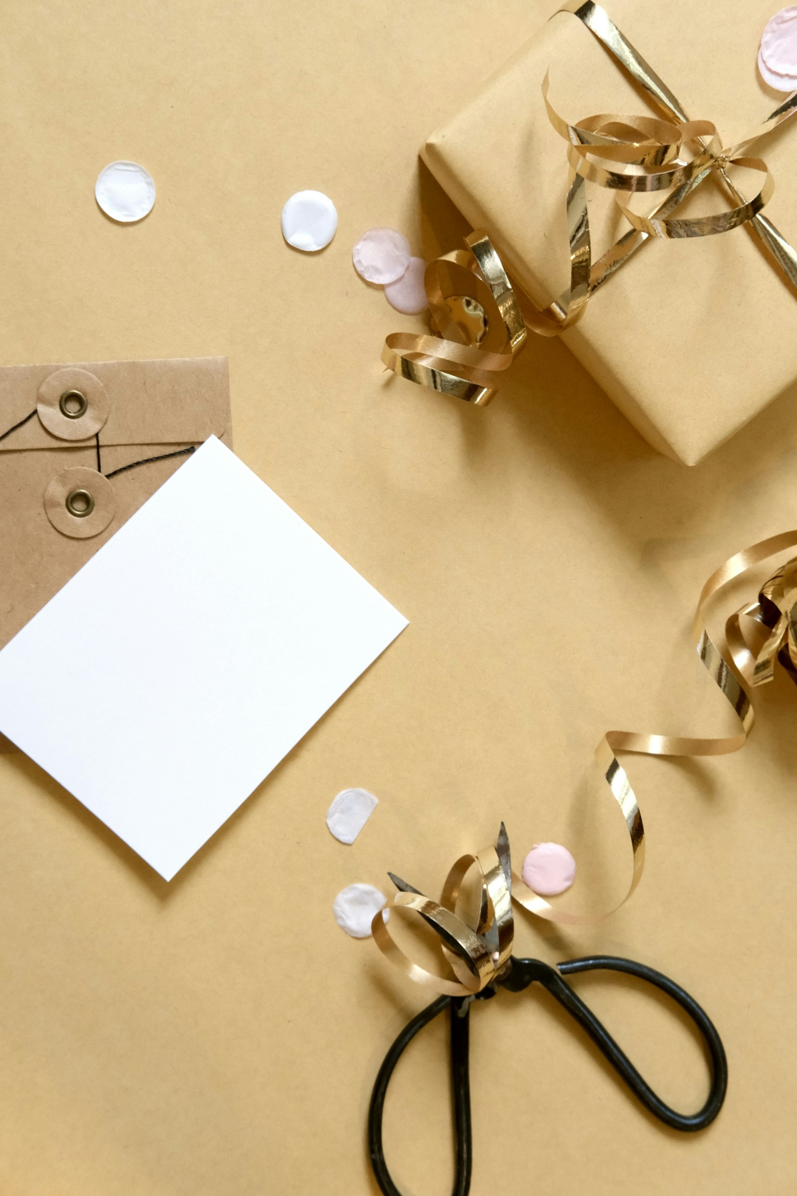 Gift wrapping setup with ribbon, card, and scissors