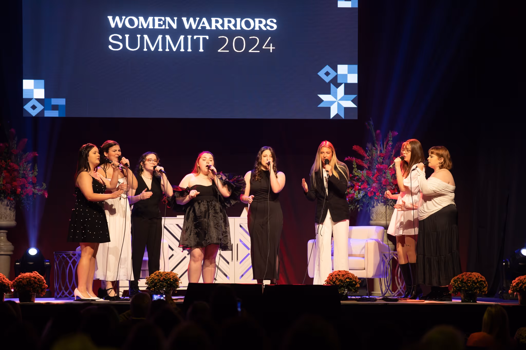 Group of women singing on stage