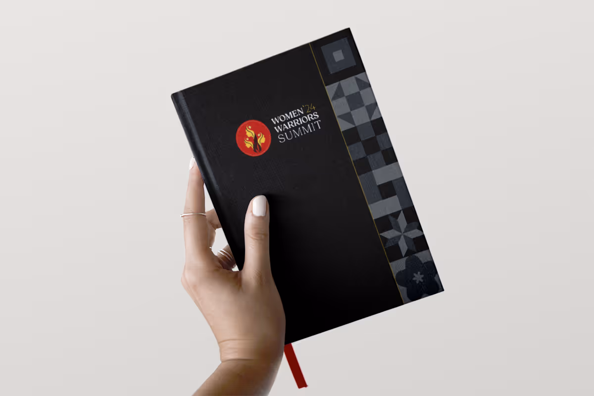 Hand holding a hardcover notepad