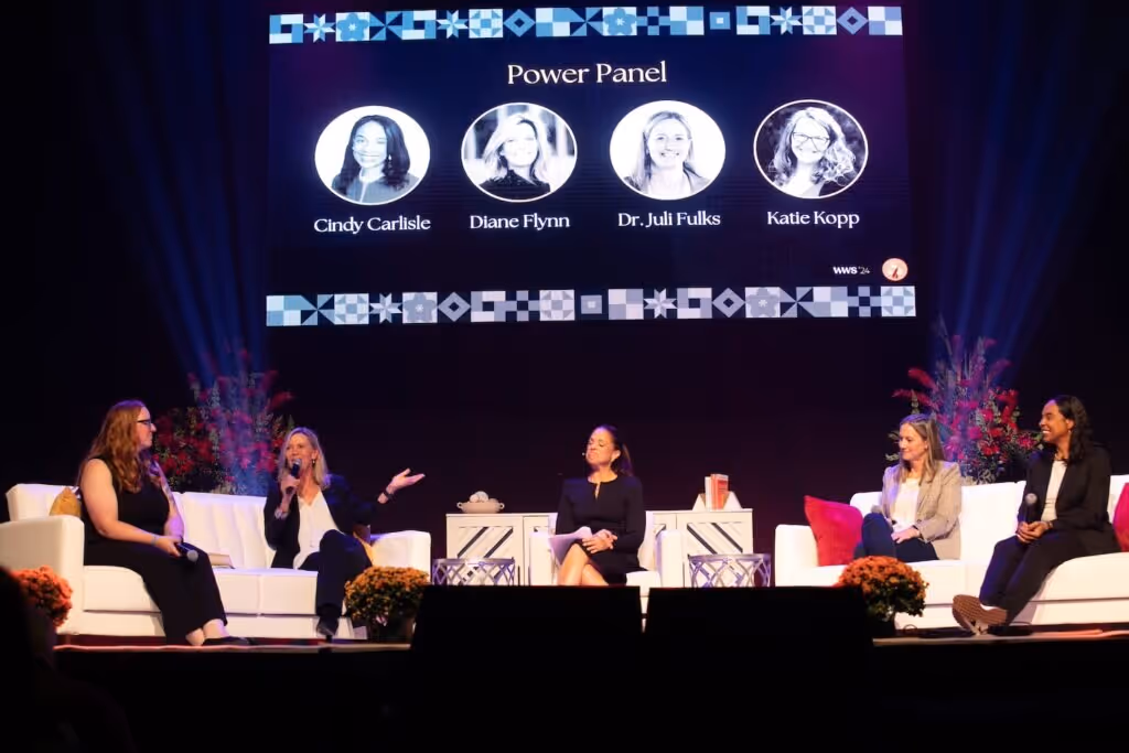 Five women on stage for a panel