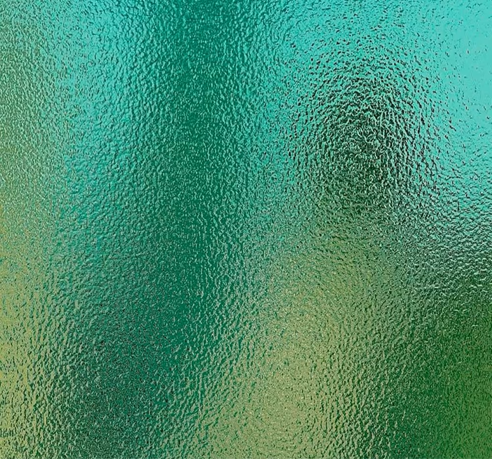 Close-up of textured, frosted glass with greenish-blue hues creating a blurry abstract pattern.
